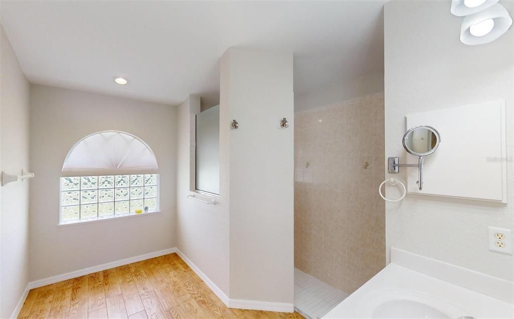 En suite bathroom with beautiful arched window.