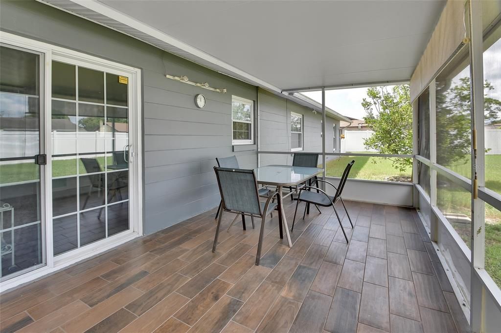 Glass sliding doors leading out to finished screened porch.