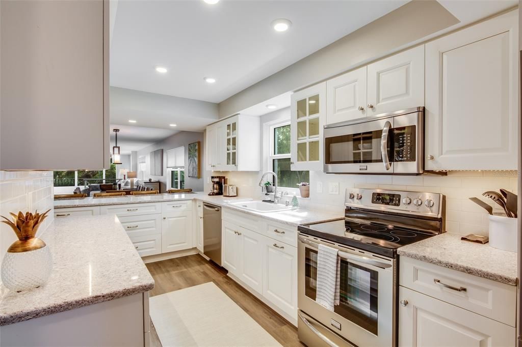 Spectacular kitchen with ample storage and counter space. Stainless steel appliances and stunning glass cabinet doors