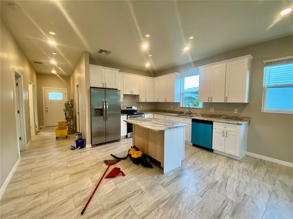 kitchen area with island, granite counter tops