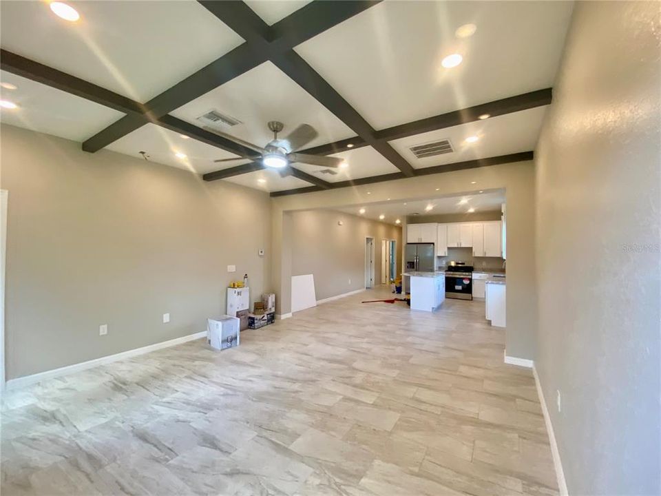 great room with coffered ceiling, recessed lights