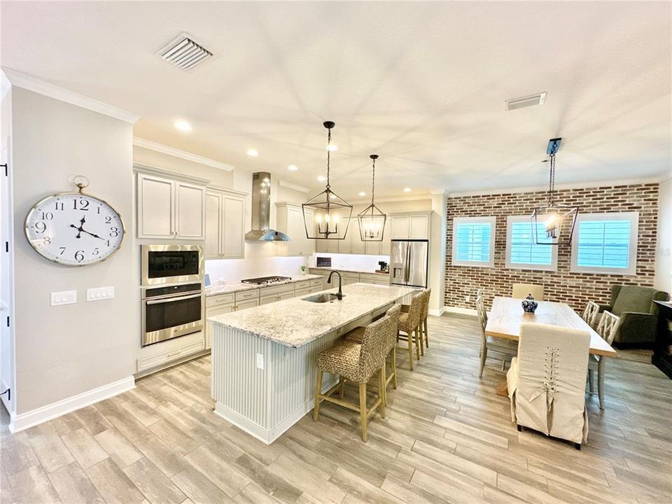 A look to the kitchen area including prep area, cook area, island and dining area 3