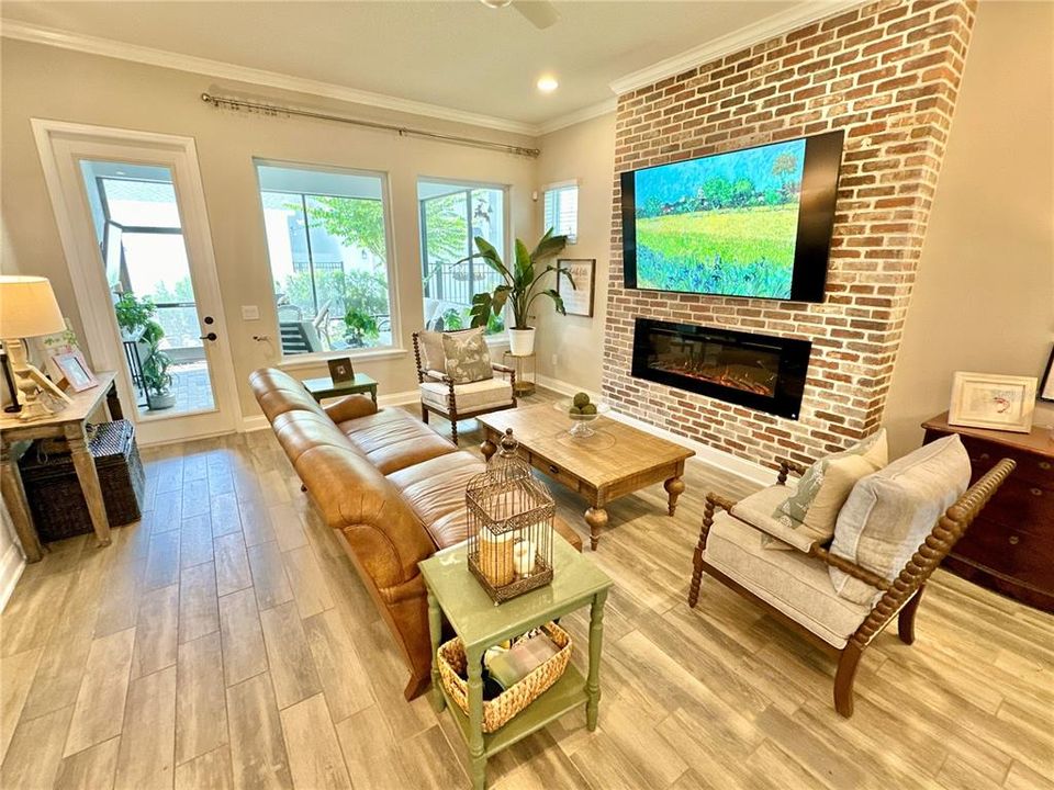 Great Room with Fire Place and Brick Wall + Lanai View