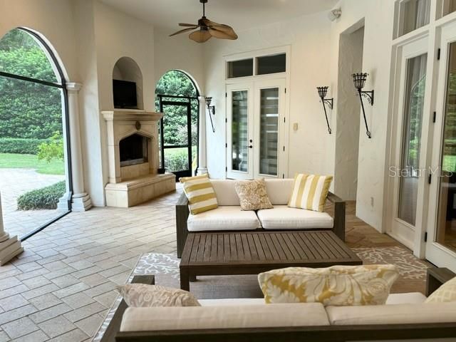 Screened Living Area with gas fireplace and entertainment