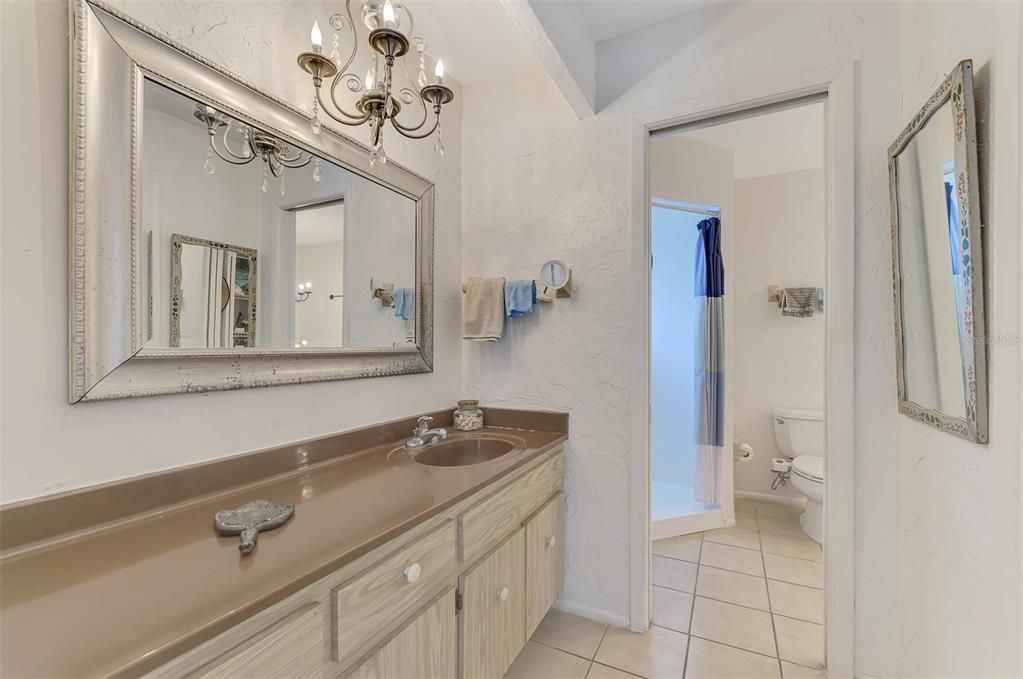 Spacious primary bathroom with dual vanity. Enjoy getting ready in this relaxing space, featuring a large mirror and plenty of counter space.