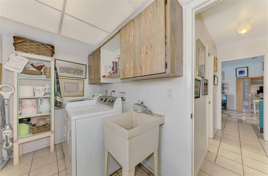 Laundry room with storage space and mud room sink