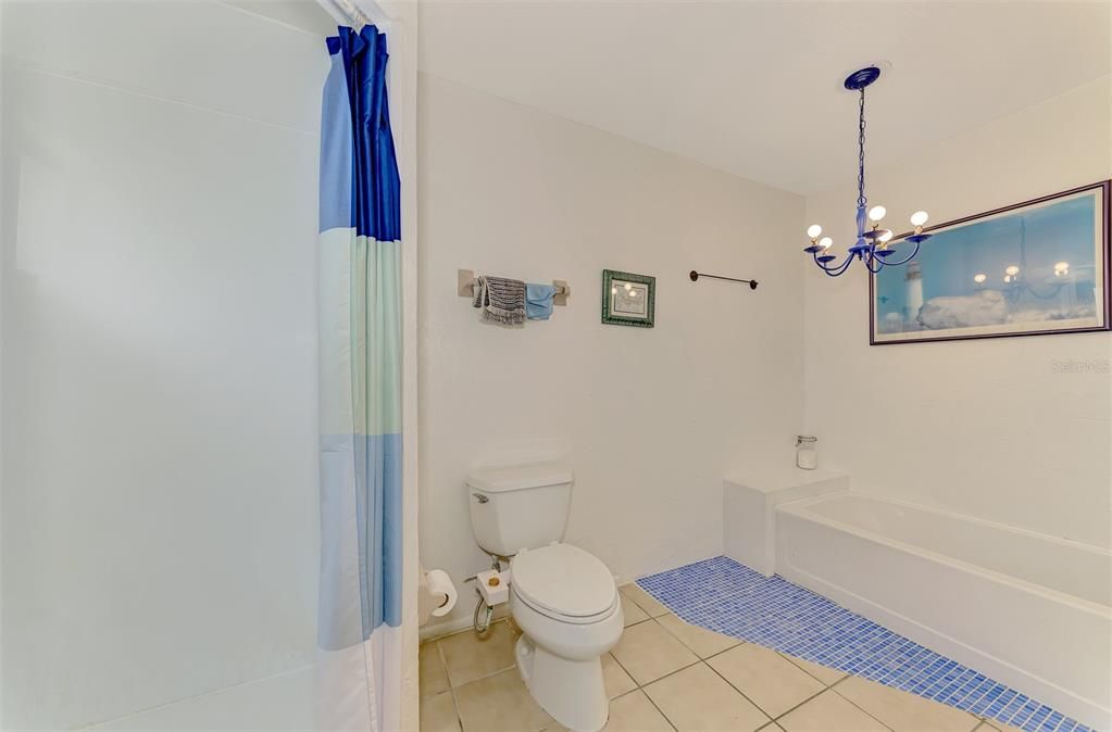 Spacious master bathroom with a deep soaking tub. Relax and unwind in this luxurious bathroom, featuring a large tub perfect for soaking away the stress.