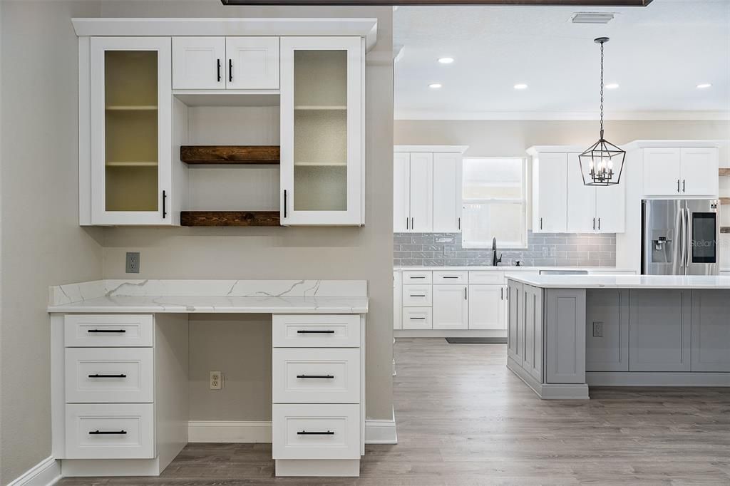 Dining Room (12'X15") which is open to the Living Room and Kitchen area. Nice built in dry bar/buffet with quartz countertop that matches kitchen quartz.