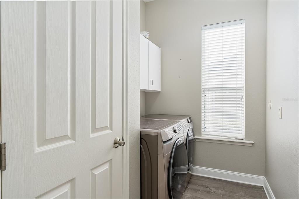 Laundry Room (6'x8')The laundry has a storage closet and cabinets above the washer/dryer. Located across from the pantry and beside the access to the garage.