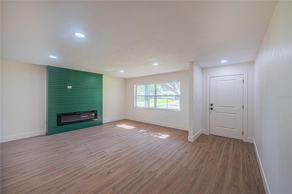 Living room looking towards front door and fireplace.