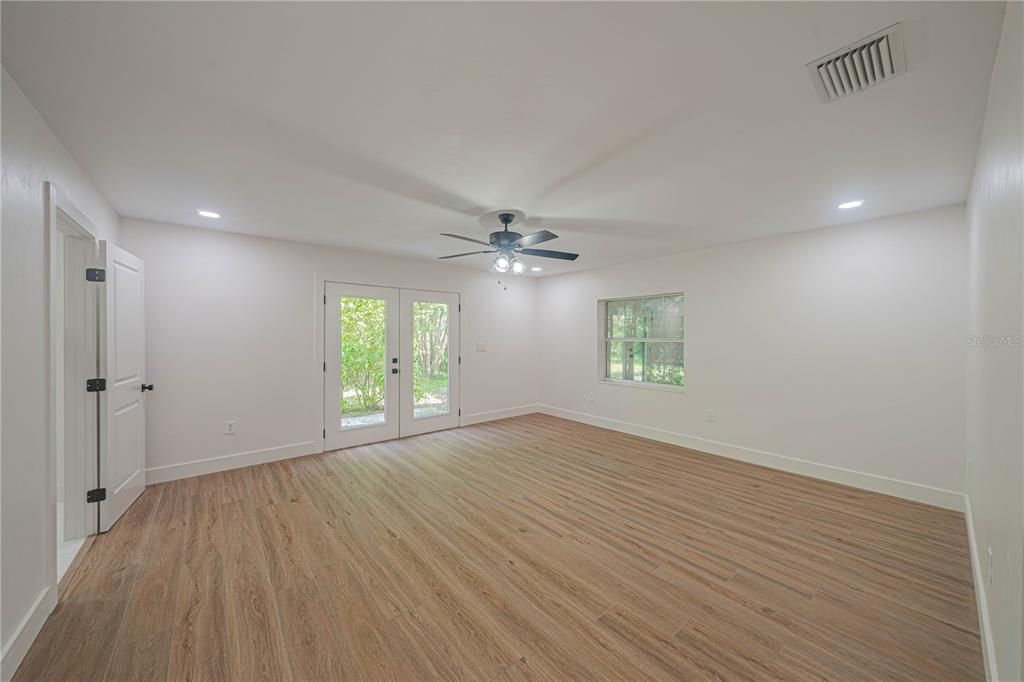 Primary bedroom with french doors to porch.