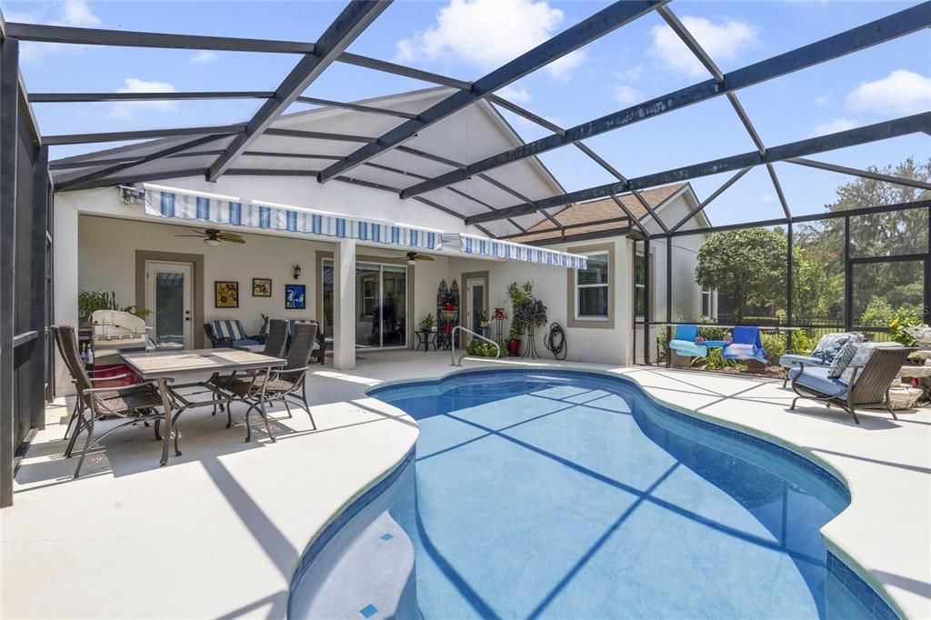 30' x 36' screen enclosed patio w/ pool that is ideal for entertaining & to relax