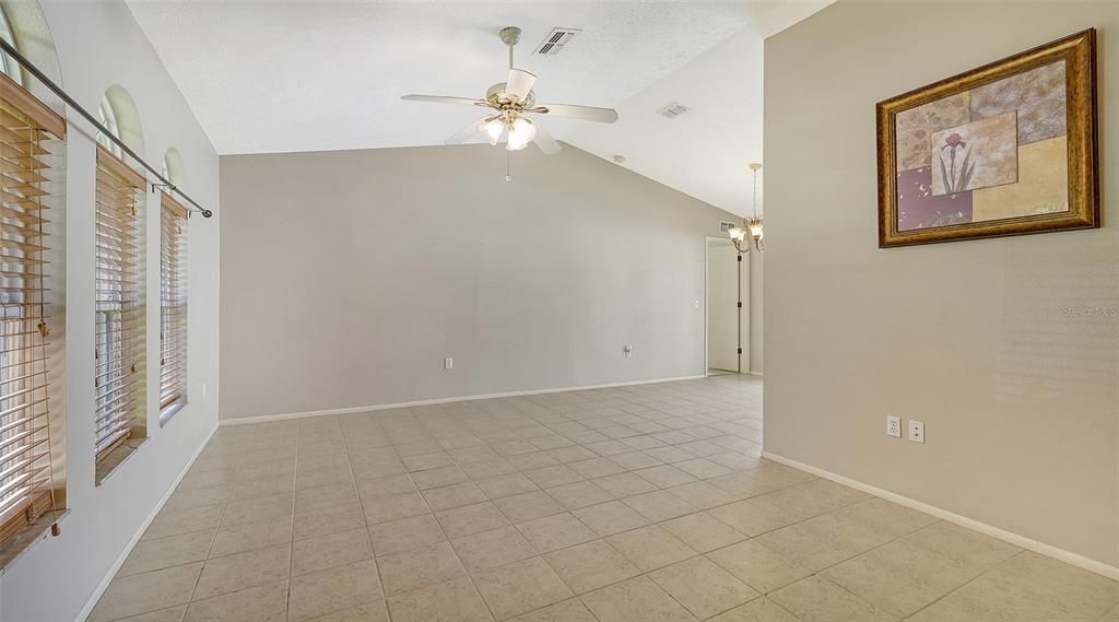 Living Room as seen from entrance hallway -- to the right is the dining area.  Tiled living room and dining area.