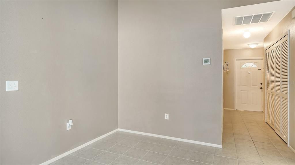 View of Front Door and entrance hallway.  To the right is a large area to be used for storage and/or a pantry.