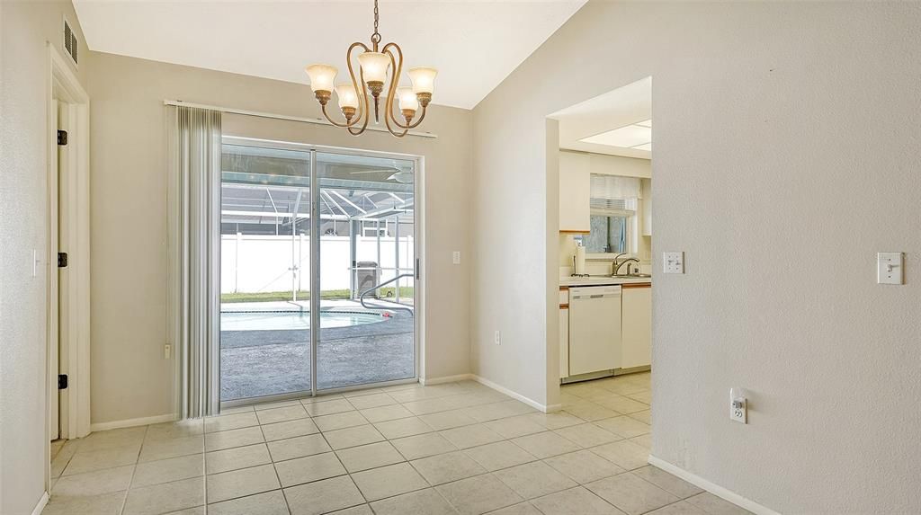 Dining area with primary bedroom to the left and kitchen to the right.