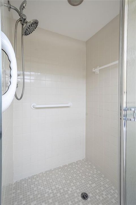 The primary ensuite features a tiled walk-in shower