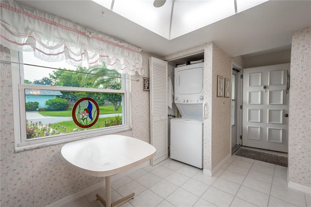 There is a laundry closet in the kitchen with a stackable washer and dryer.