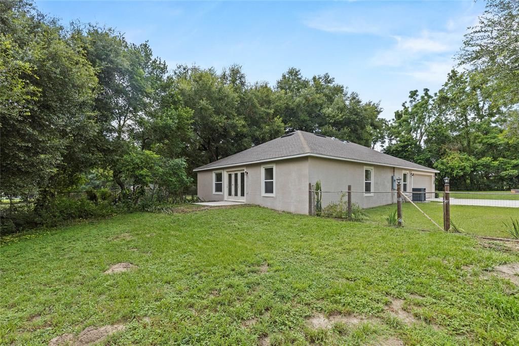 Large backyard with a treed buffer