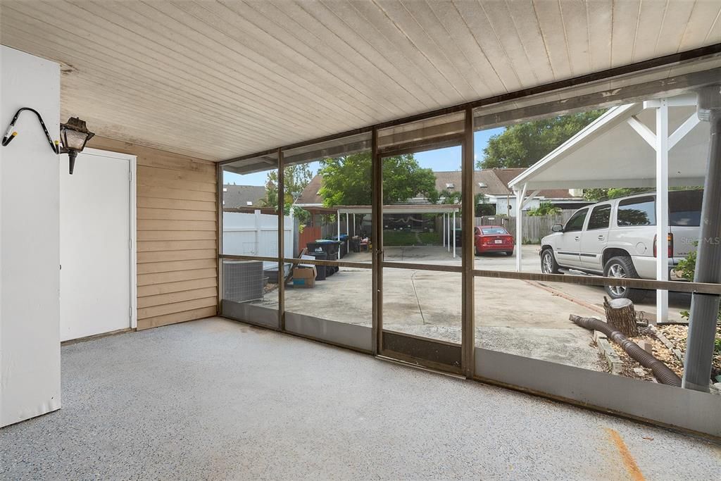 large screened in porch. To the left is laundry room. 2 rear parking spaces.