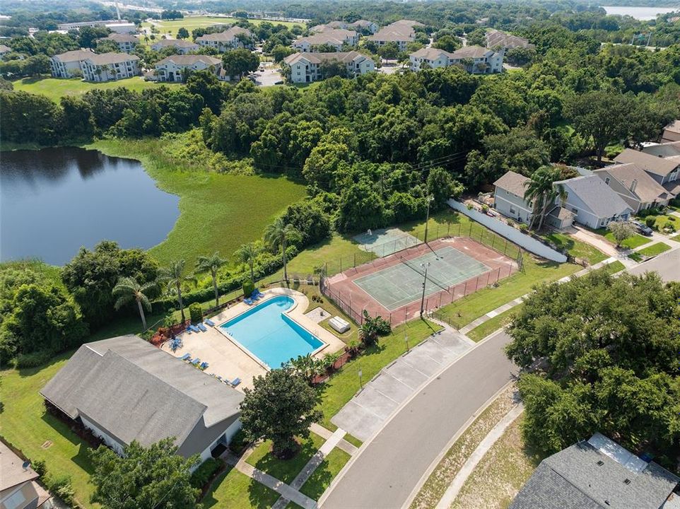 view of recreational building and community pool/tennis courts.