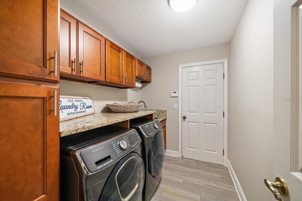 Laundry room leads to three car garage.