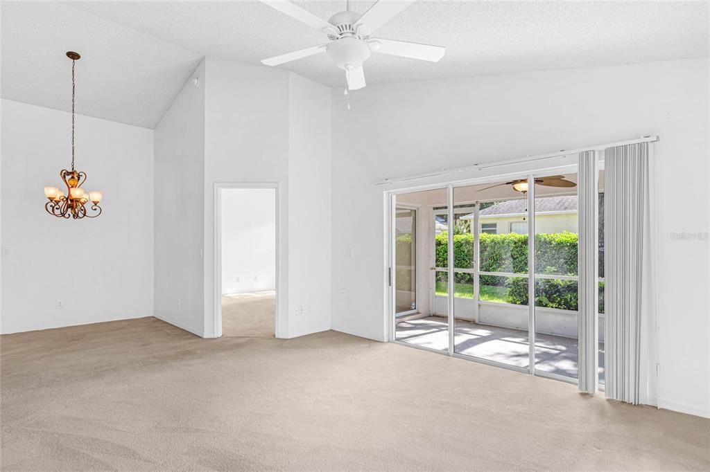 Family room has sliding doors leading to screened patio