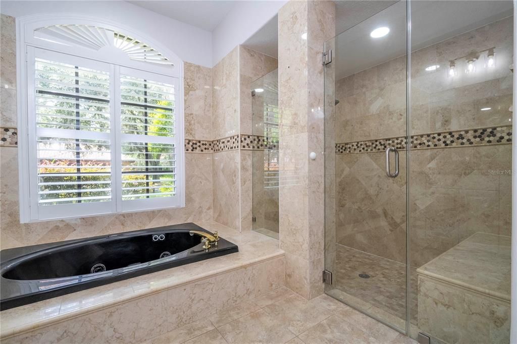 Luxurious marble tiling encasing the spa tub with jets