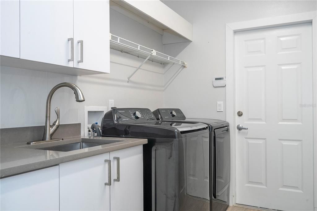 Spacious laundry room with ample storage and washing space