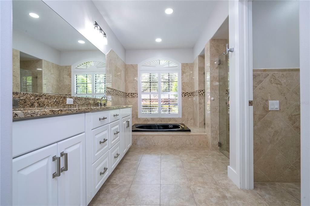 Granite, double sink, modern tile floor and marble wall tile finish