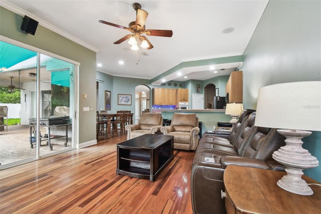 Family room off of kitchen with sliding glass doors to patio and pool