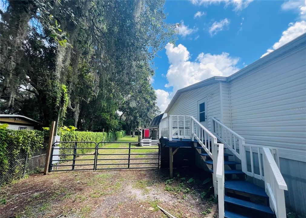 SIDE YARD VIEW FROM DRIVE WAY WITH DOUBLE GATE