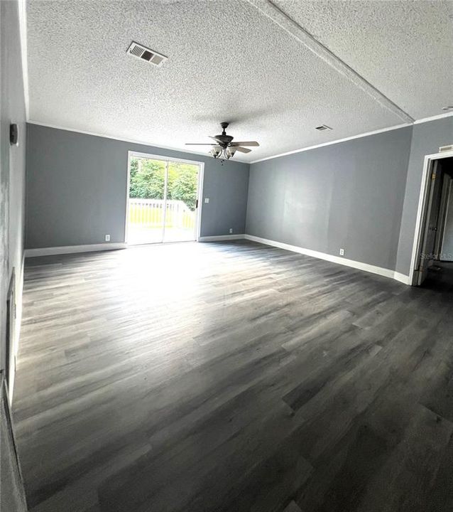 FORMAL LIVING ROOM WITH SLIDING GLASS DOORS TO BACK YARD