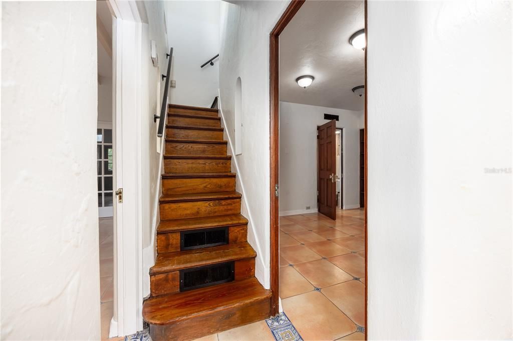 Stairs to the two upstairs guest bedrooms, full bathroom and rooftop terrace