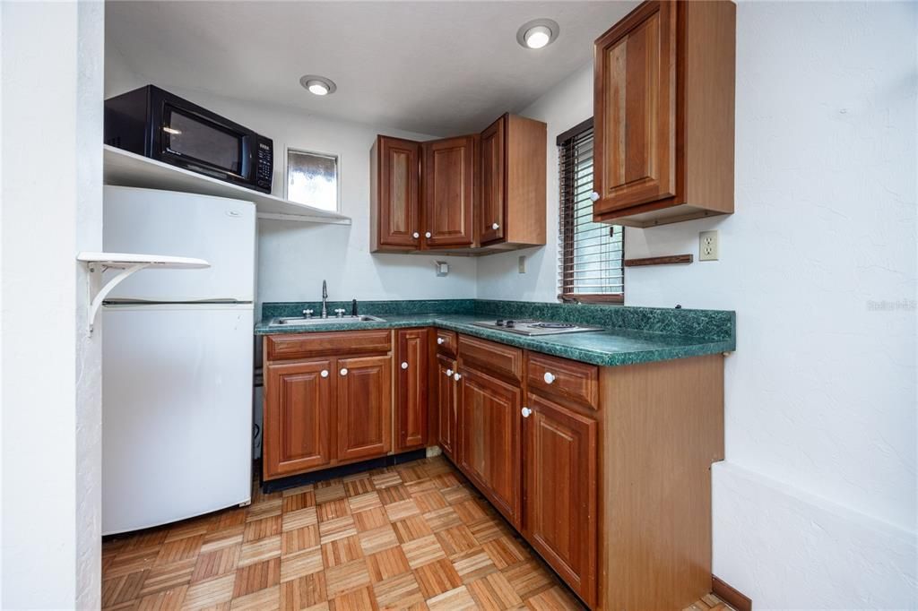 Kitchenette with sink, range, refrigerator and microwave