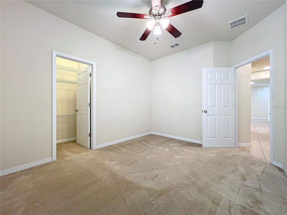 Bedroom #2 with walk in closet and ceiling fan