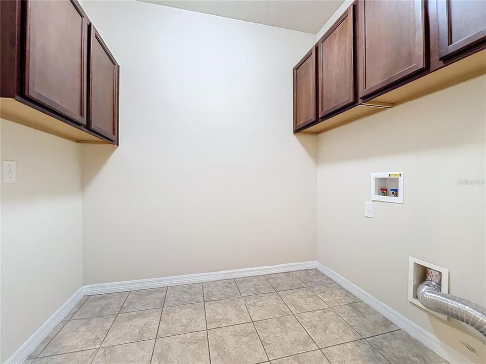 Laundry room with upper cabinets