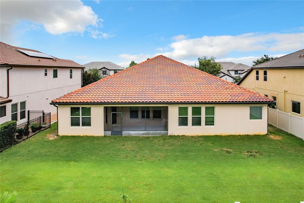 Home features exterior concrete block construction and a stunning barrel tile roof