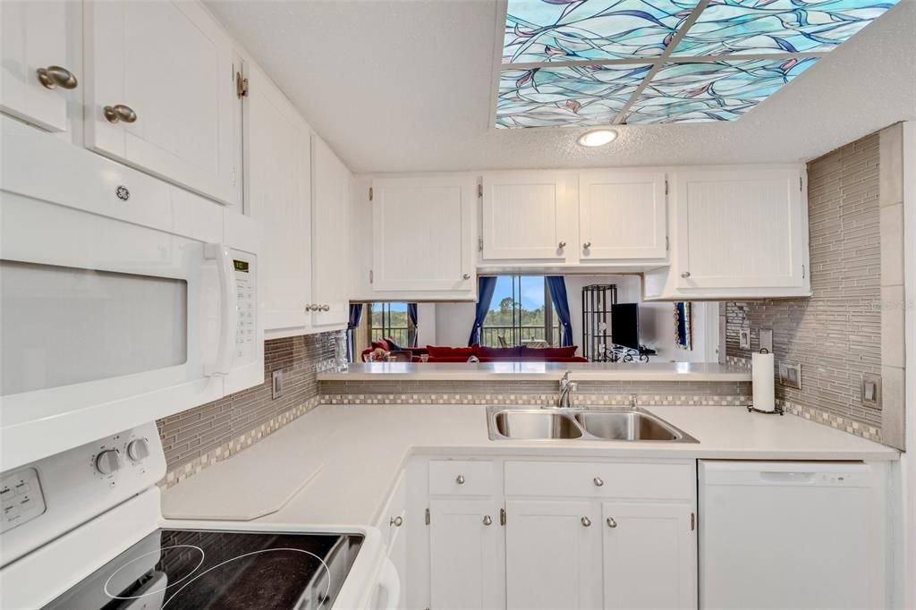 Tile backsplash; pass through with a view into the great room and out into the lanai