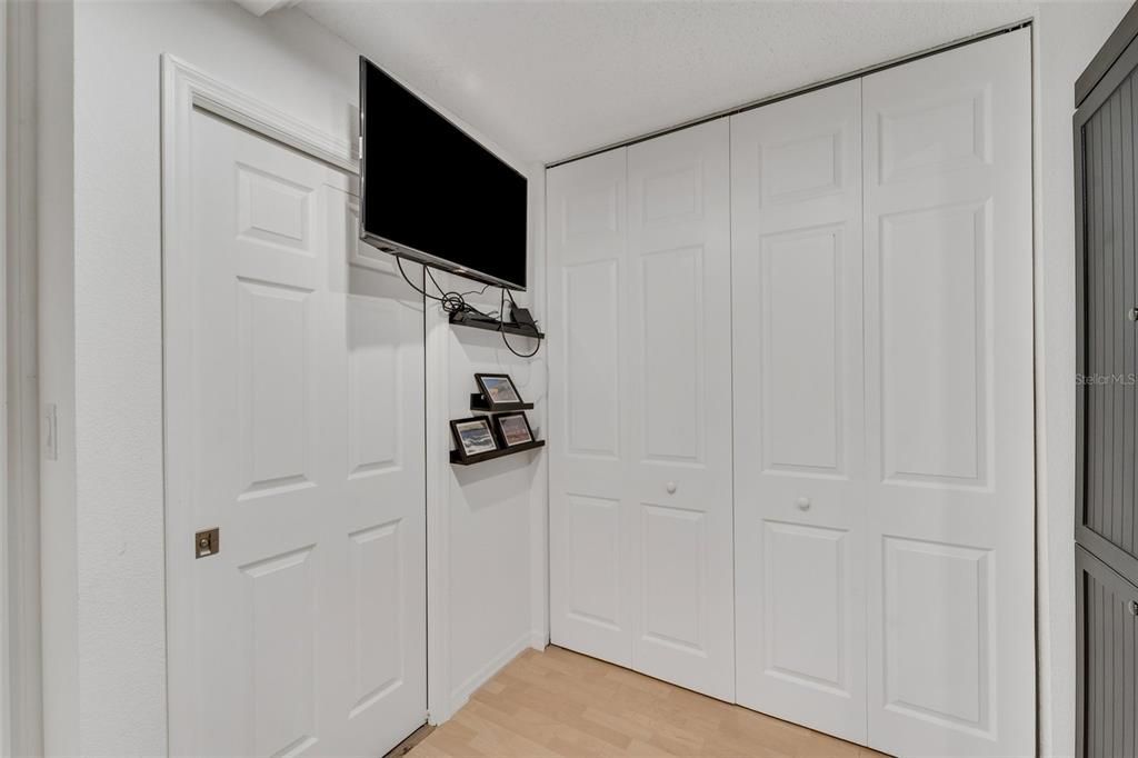 Another view of large storage closet on the left with the TV