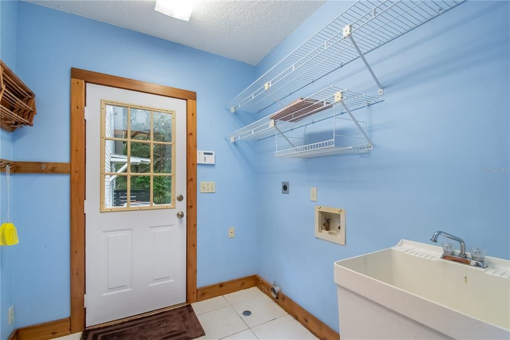 laundry room with 1/2 bath and utility sink