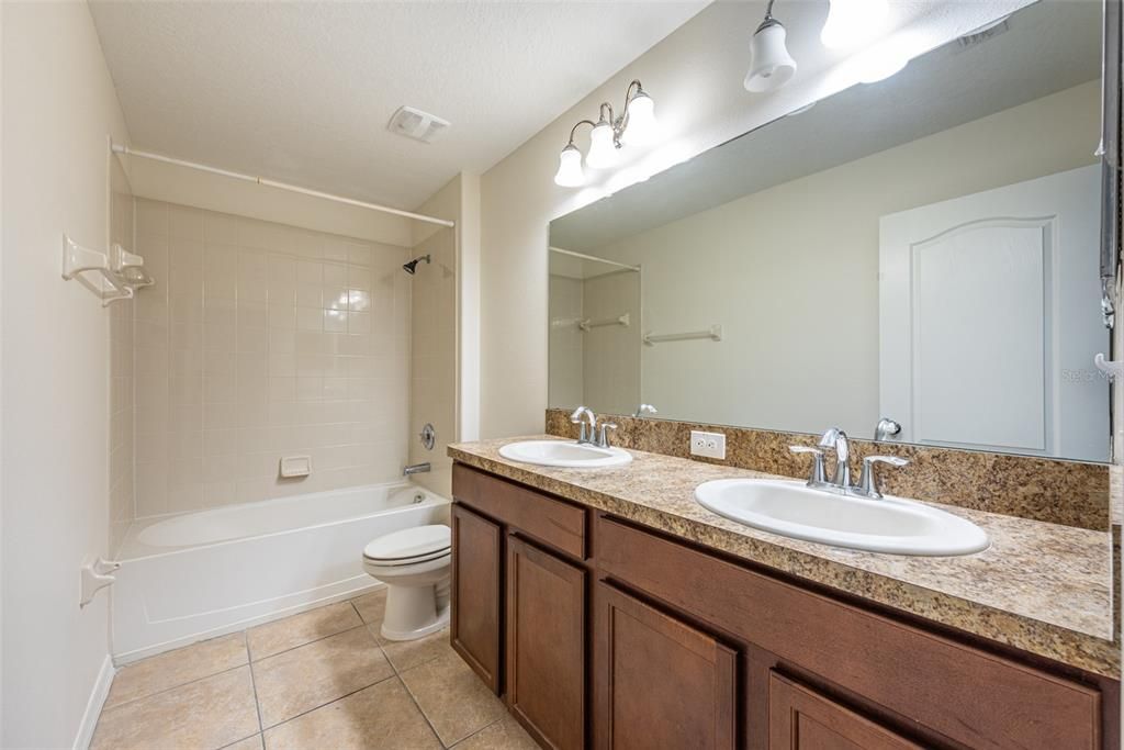 Bathroom #2 on 2nd floor with two sinks is shared by 4 secondary bedrooms.