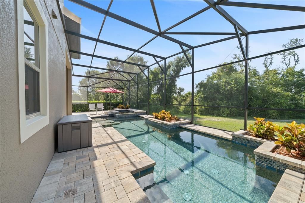 Pool installed in 2018 has tranquil views of trees and  beyond