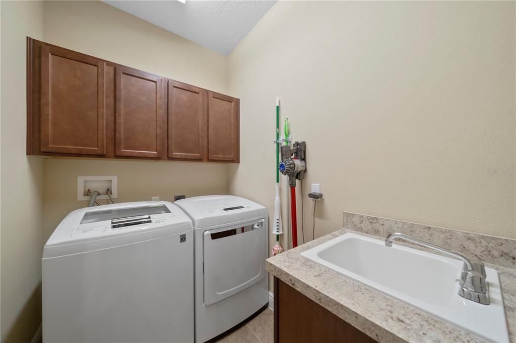 Laundry room with cabinet storage, sink and washer/dryer included