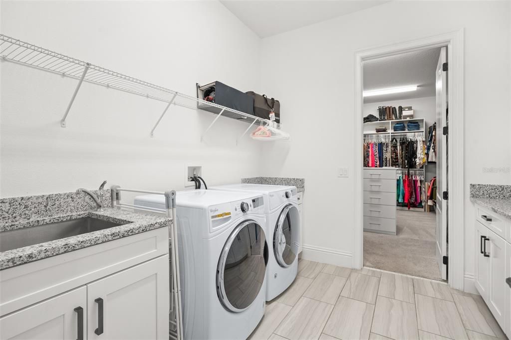 Laundry room off primary close with access to entryway.