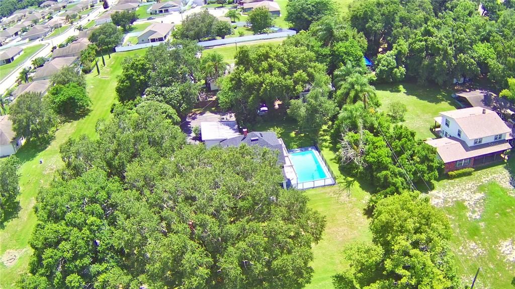 Aerial of the property. Apartments are at the back under the trees.