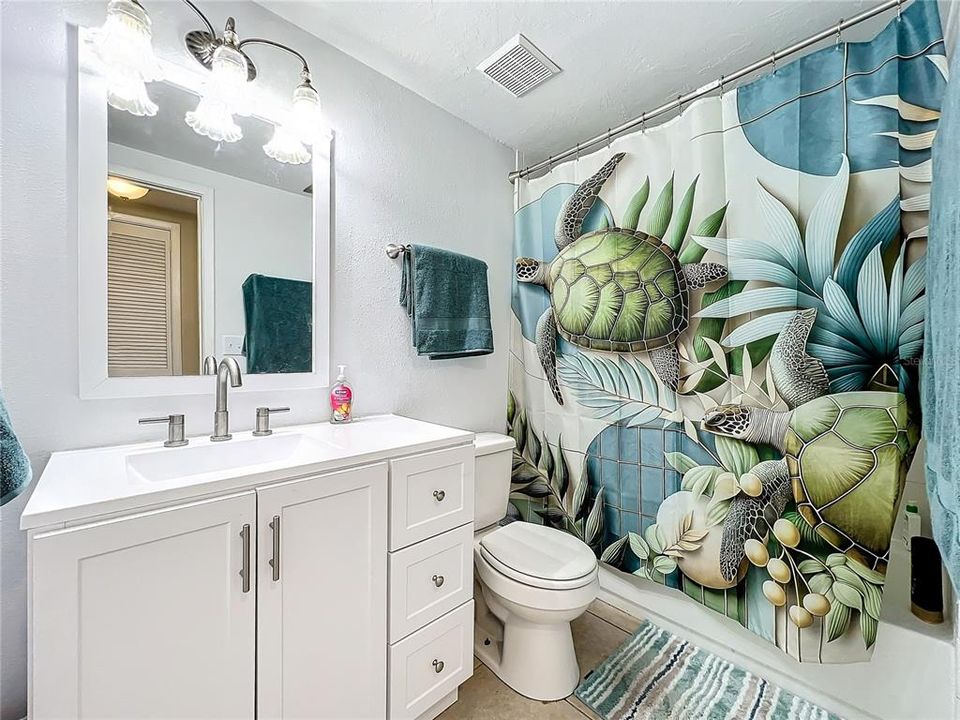 Guest bathroom offers a tub/shower combination.