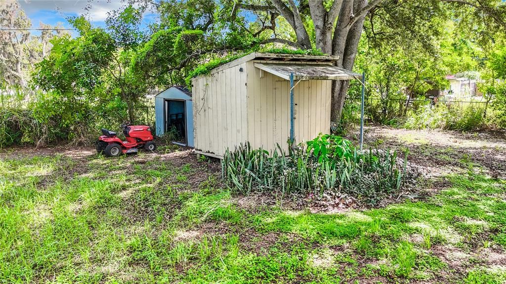 Two sheds in backyard.