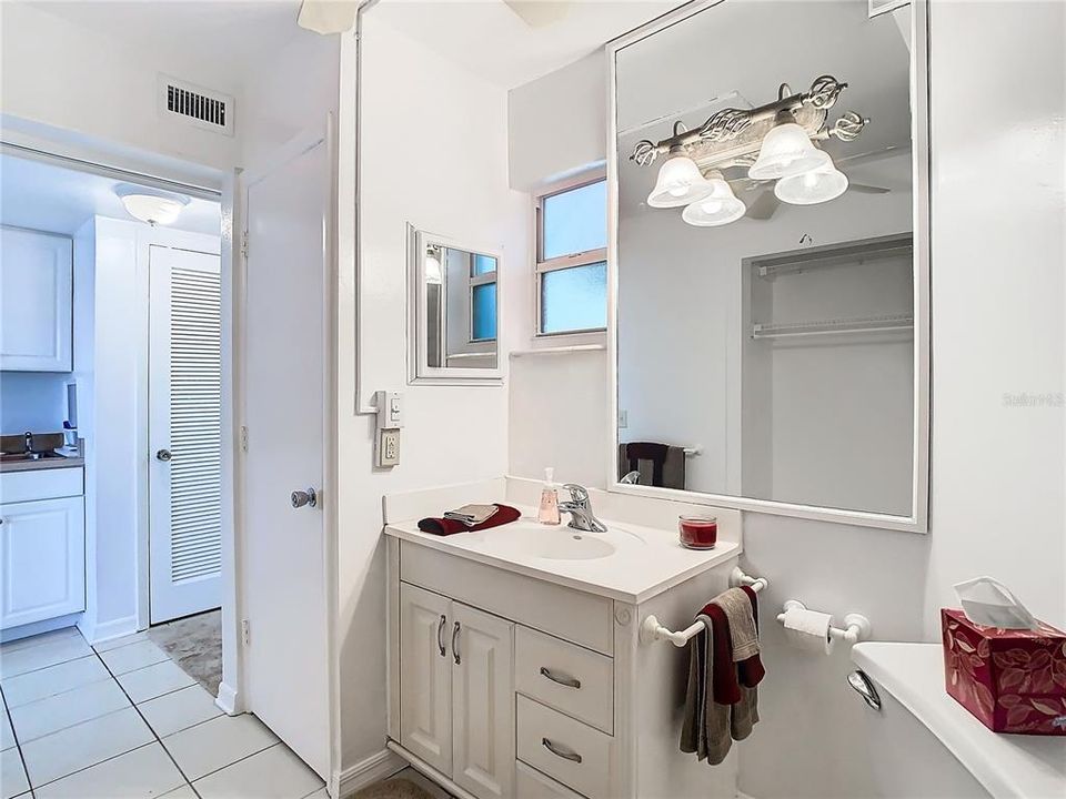 Your back is to the shower, view towards vanity, Water heater is in the closet next to the vanity. The louvre door directly ahead is the HVAC closet. The front door is to the right of that.