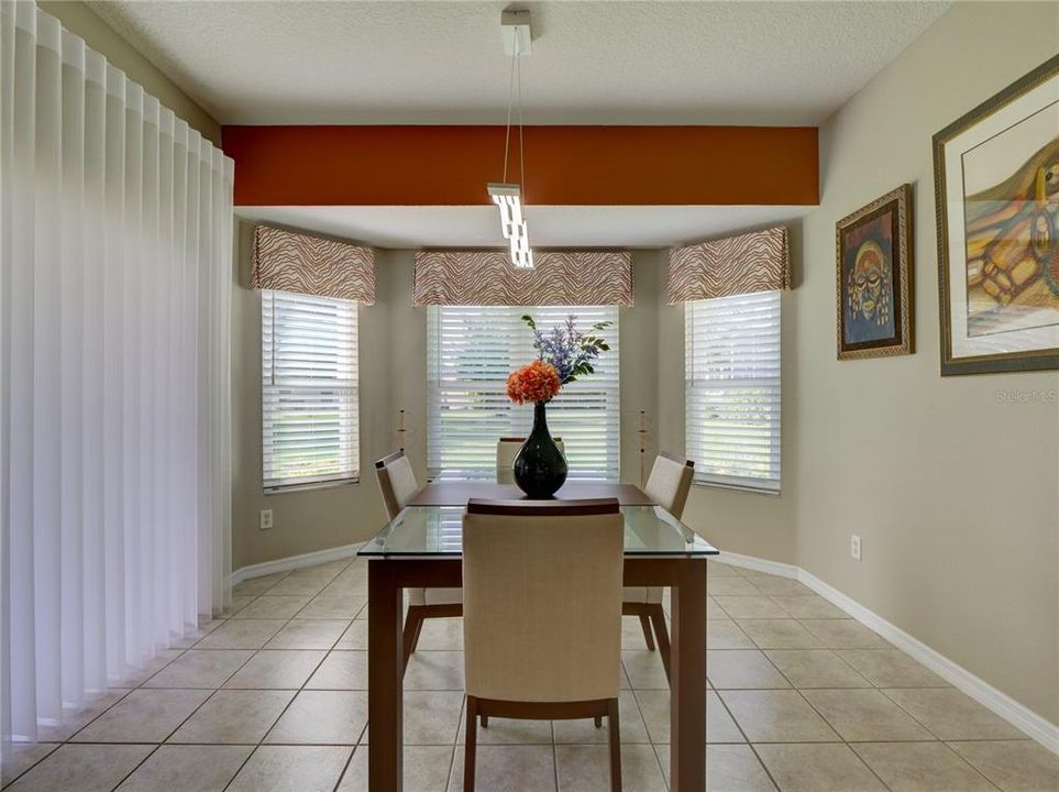 Dining Room with Bay Windows and Custom Valances and Verticals