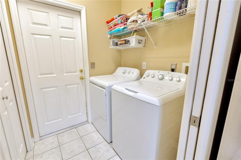 Inside laundry room with pantry closet